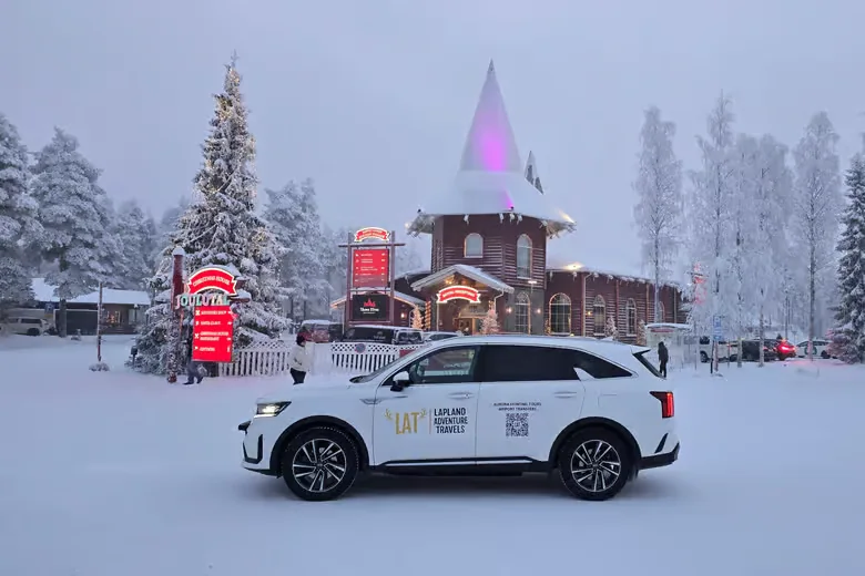 Lapland Adventure Travels car outside Santa Claus Village in winter