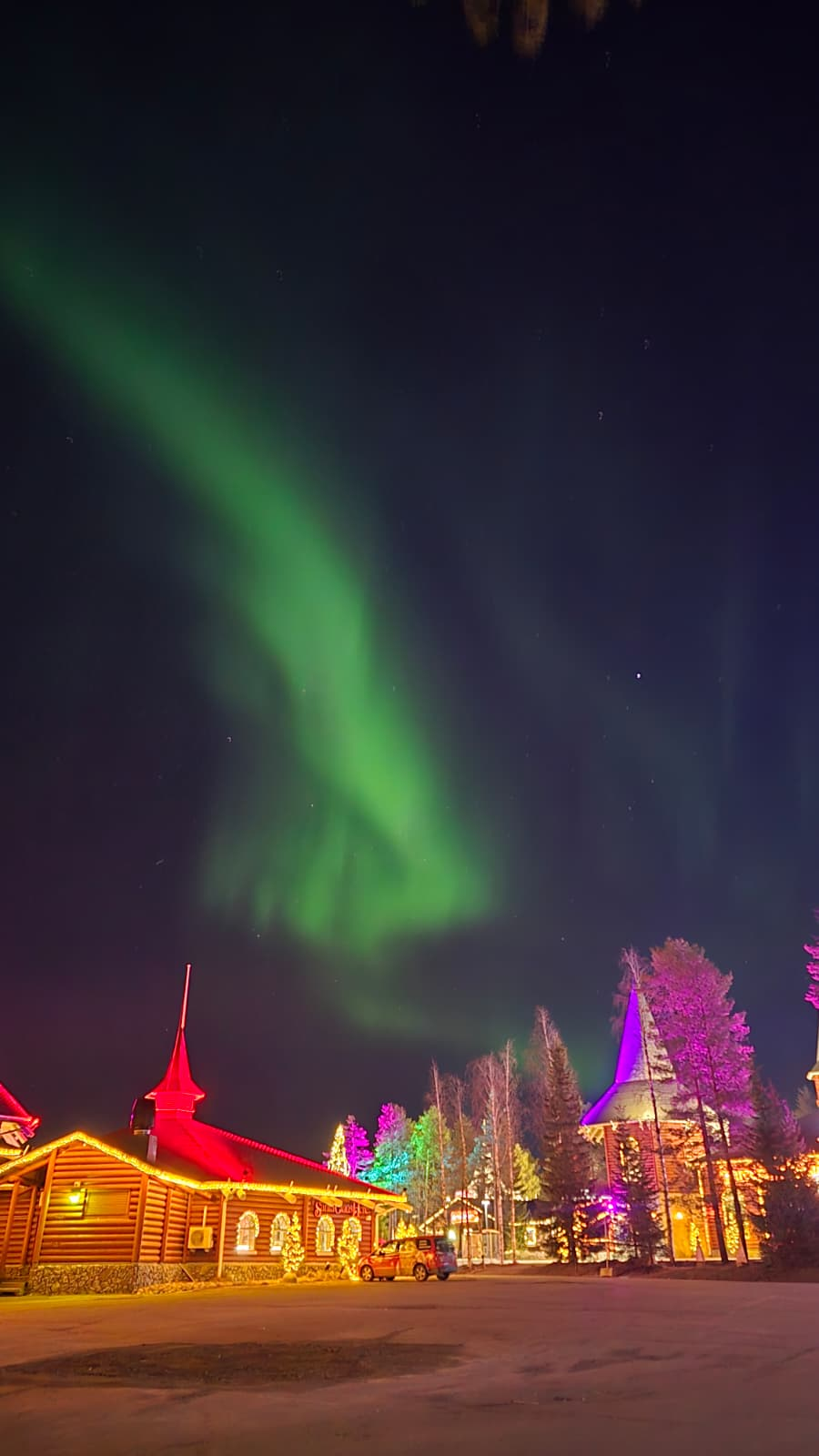 Northern Lights and travellers in Lapland