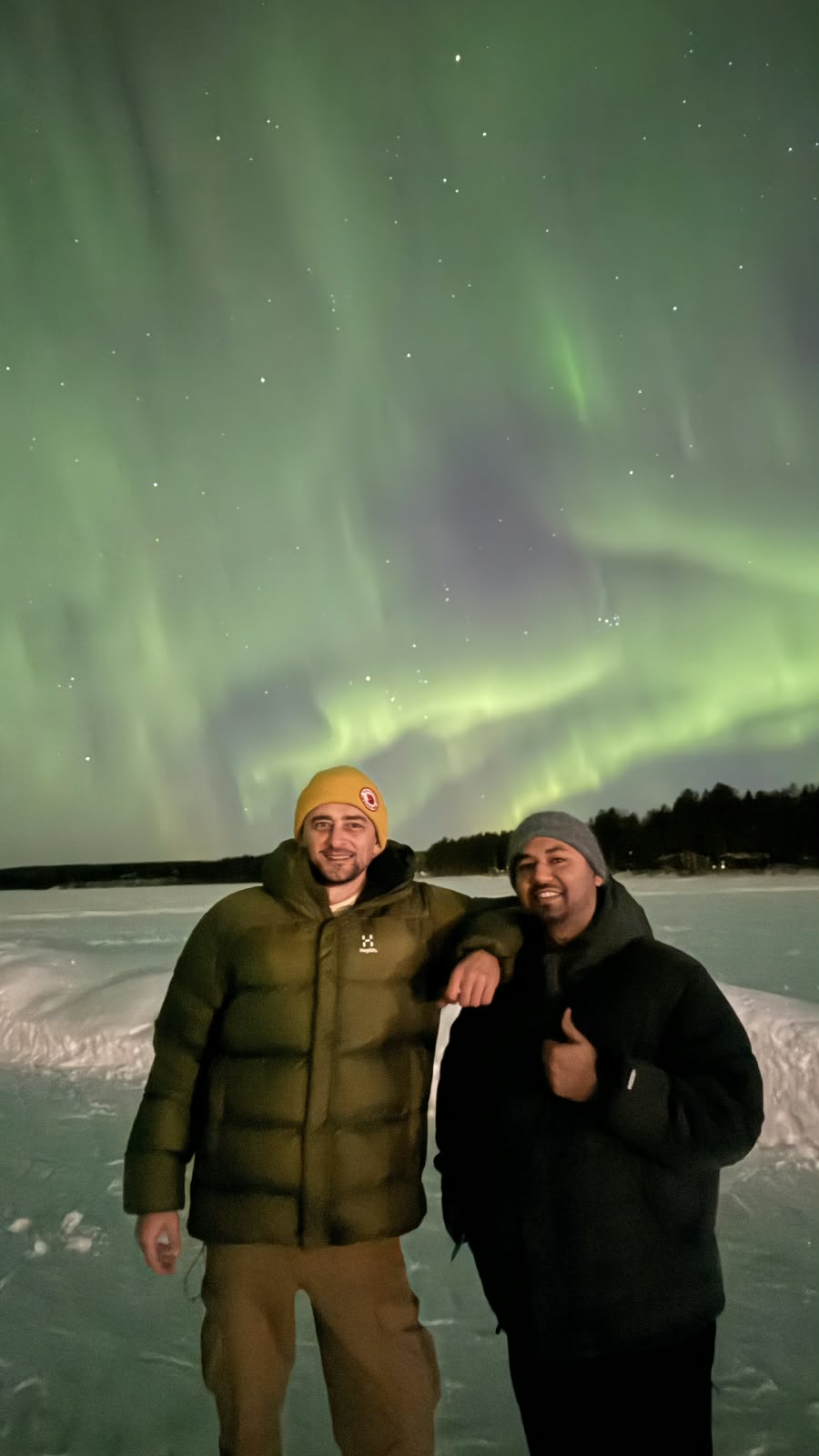 Northern Lights and travellers in Lapland