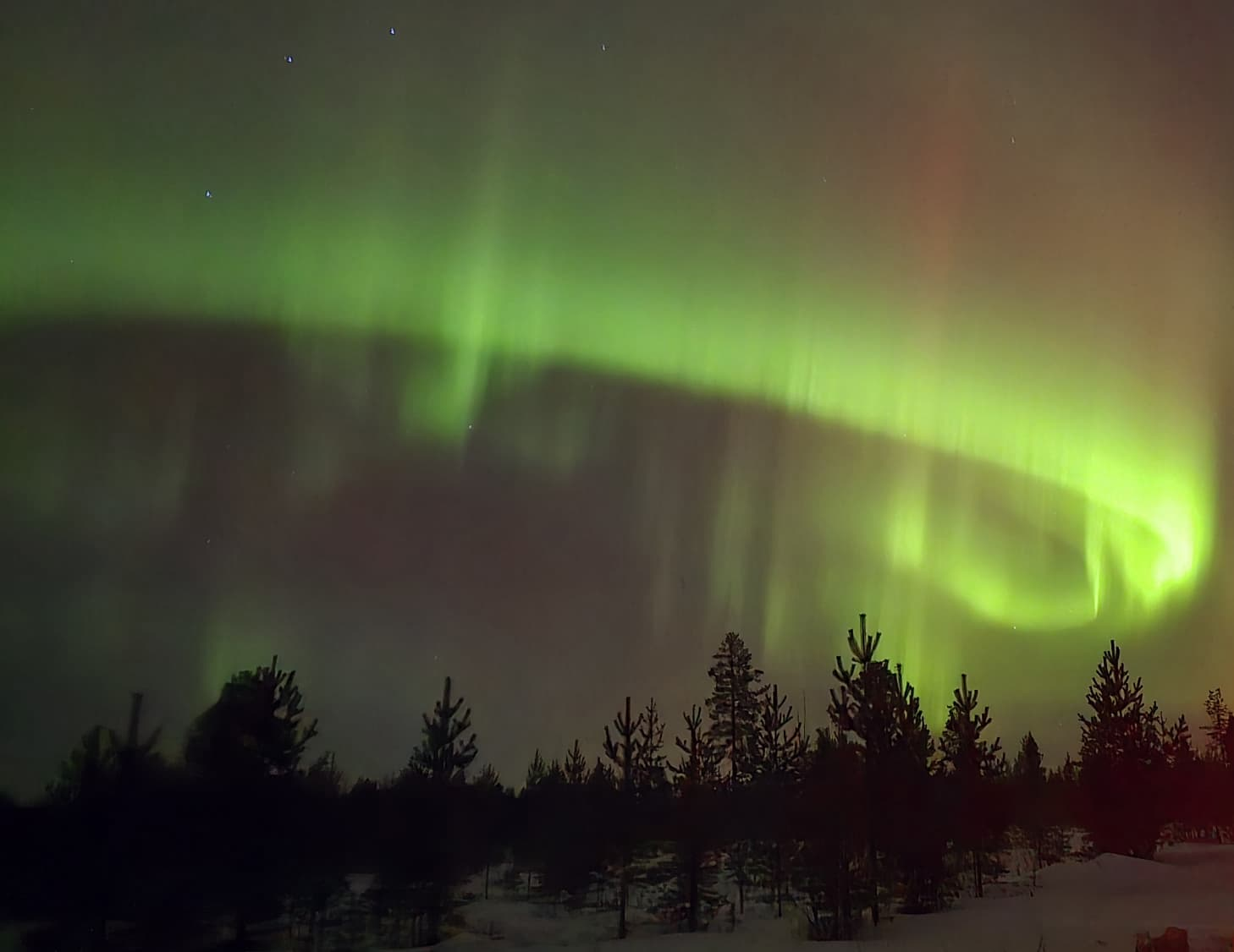 Northern Lights and travellers in Lapland
