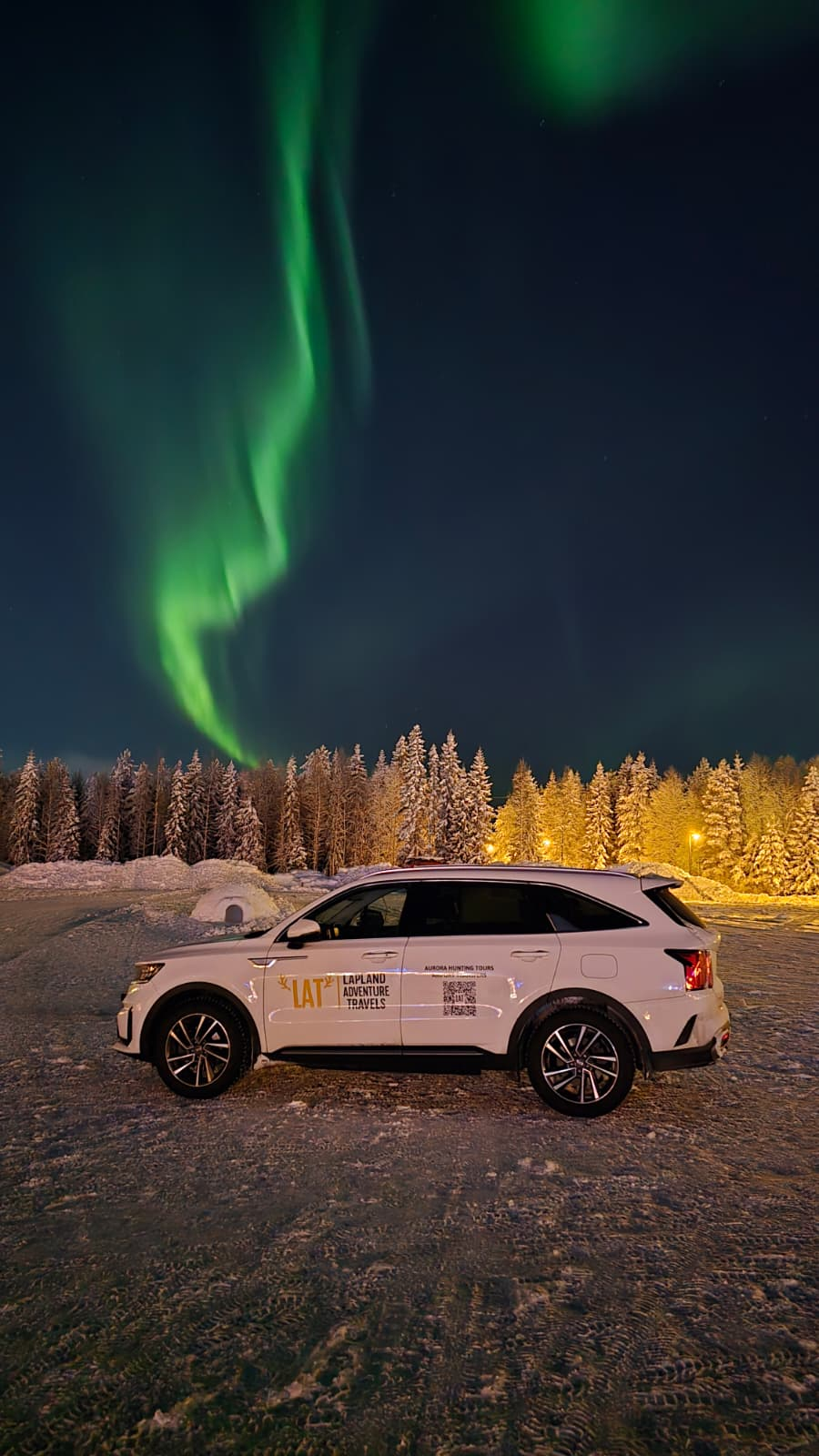 Lapland Adventure Travels vehicle under the Aurora